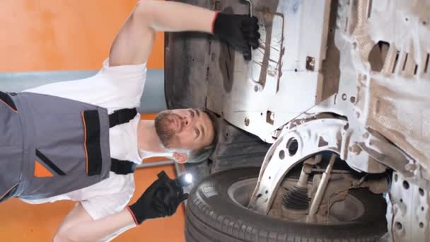 Young Car Mechanic Screws Car Parts Special Tool Raised Car — Wideo stockowe
