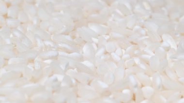 Close-up of a large number of grains of white rice spinning on camera. Croup. Seed