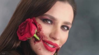 Makeup with a rose flower in the mouth for the Day of the Dead. A Mexican tradition for the Day of the Dead.