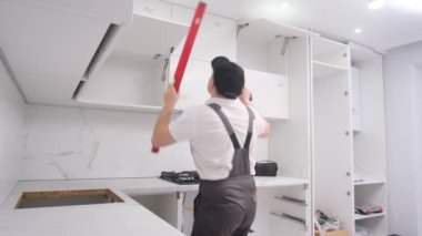 Funny and cheerful european man dancing and having fun while listening to music while renovating the room. High quality 4k video