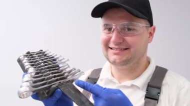 Portrait of a mechanic holding repair keys on a white background. Car repair concept. 4k video