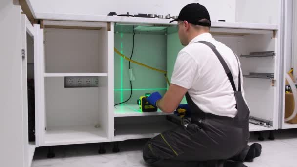 Worker Installs Furniture Kitchen Master Uses Electronic Laser Repair New — Video Stock