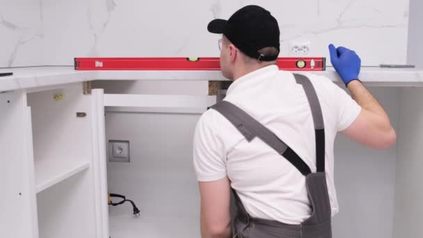 Repairman Assembles Furniture Kitchen Uses Level Tool Professional Installation Furniture — Video Stock