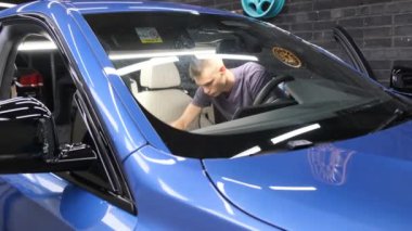A car service worker washes a car with chemicals. Modern car interior cleaning. 4k video