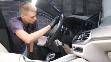 A car service worker washes a car with chemicals. Modern car interior cleaning. 4k video