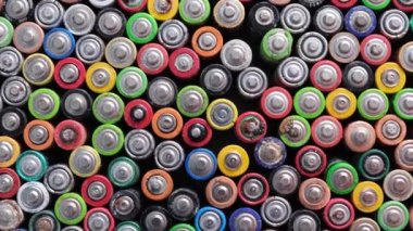 Used batteries are hazardous to the environment. Top view of multicolored used electric batteries.