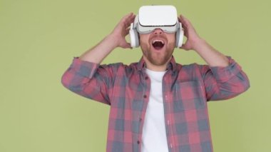 Surprise in virtual reality glasses. Emotions of a young guy. Looking to the future