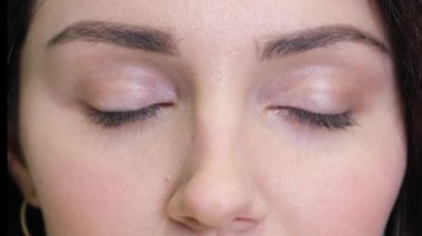 Close-up of a woman who opens her eyes wide and looks at the camera. Concept of different races of people. Girls view, macro shot