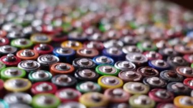 Recycled batteries. Rotation around a group of colored batteries. Disposal of hazardous waste.