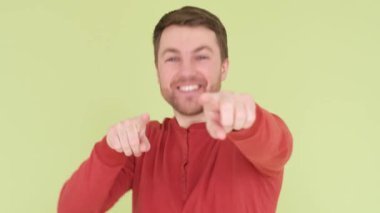Close up of a cheerful guy dancing to the camera. Good mood. Shooting in the studio