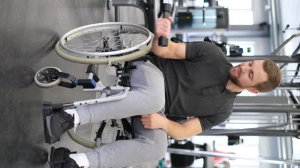 Vertical Video Young Attractive Smiling Man Wheelchair Lifting Dumbbells Gym — Stock video