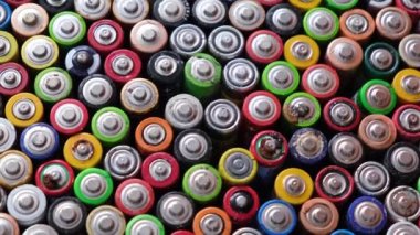 Finger batteries - benefits and dangers for the environment. Discharged AA batteries are stacked evenly.