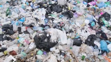Ecological catastrophe for nature, the concept of environmental pollution. Polluted ocean beaches with plastic waste, garbage platform.