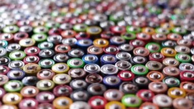 Recycled batteries. Rotation around a group of colored batteries. Disposal of hazardous waste.