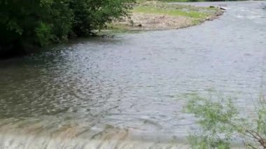 Dağ nehrinde bir sürü plastik şişe var. Plastik şişelerden şelale