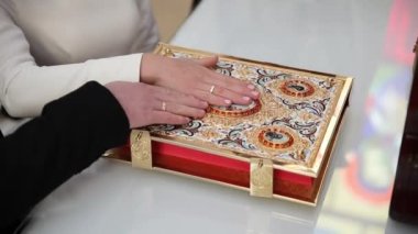 Close-up of hands of bride and groom in Christian church during wedding vows. Wedding day