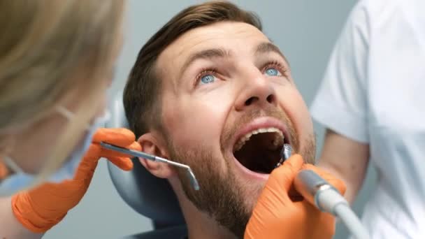 Closeup Woman Dentist Examines Young Mans Teeth Dental Tool Modern — Stock video