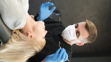 A beautiful elderly woman of European appearance at the dentists appointment. A retired woman treats her teeth in a dentists office. A beautiful smile in old age. Vertical video
