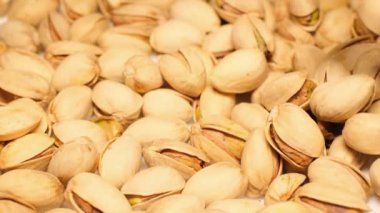 Pistachios background. The view of the top. Closeup view of pistachios isolated on white background