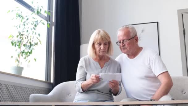 Upset Elderly Couple Checking Financial Documents While Calculating Family Budget — Video
