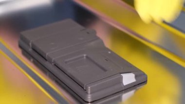 A womans hand inserts the powder for the dishwasher into a special compartment. Close up