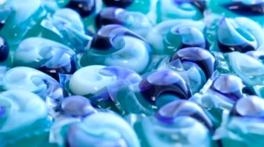 Background of gel capsules for washing clothes, capsules with detergent for washing machines. The concept of laundry and dry cleaner. 4k video