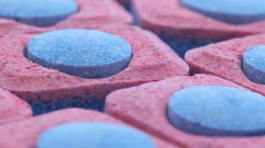 Macro video background with dishwasher capsules. Dishwashing concept.