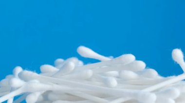 Yakın plan plastik pamuklu çubuklar, mavi arka planda pamuklu çubuklar. Yüksek kalite 4k video