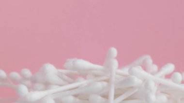 Close up of cotton swabs on a pink background, plastic cotton swabs. High quality 4k video