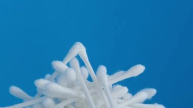 Hygiene products, cotton buds on a blue background. 4k video