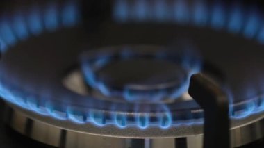 Karanlık bir odada yanan bir gaz ocağının yakın çekimi. Doğal gaz kullanımı. 4k video