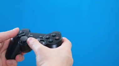 A young man plays a game console. Gamer and computer video games on chromakey background. The streamer holds a joystick in his hands. Addiction to computer games