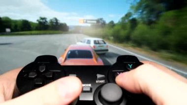 Close-up of a players hands playing a car racing video game on a console using a joystick. High quality 4k video