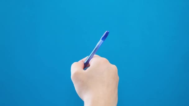 Male Hand Writing Ballpoint Pen Short Strokes Blue Background Video — ストック動画