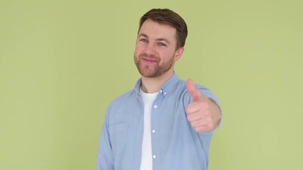 Portrait Guy Showing Thumbs Studio Background Laughs His Eyes Light — стоковое видео
