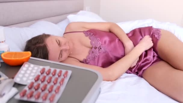 Young Woman Beautiful Pajamas Lies Bed Suffers Pain Menstrual Pain — Stock Video
