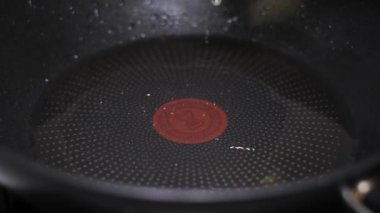 Super slow motion fried egg in a pan with oil. Preparing breakfast