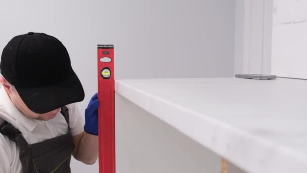 Professional Worker Checks Level Pedestal Installation Furniture White Tones — Video
