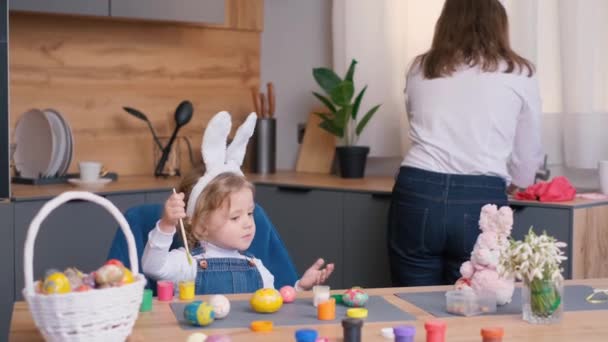 Κόρη Είναι Απασχολημένη Βάψιμο Αυγών Για Πάσχα Και Μητέρα Πλένει — Αρχείο Βίντεο