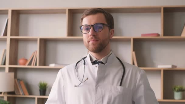 白いコートと眼鏡の医者の肖像画 彼はカメラを見て笑っている 薬の概念 — ストック動画