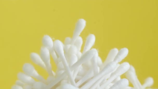 一群白色的耳朵粘在明亮的黄色背景上 旋转成一个圆圈 用于个人卫生的塑料和棉制品 — 图库视频影像