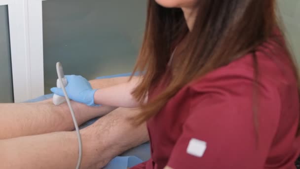 一位女医生在一家现代诊所对病人的腿进行超声波检查 老年人静脉曲张 — 图库视频影像