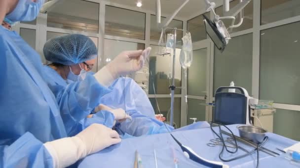 Ameliyathanede Ameliyat Sırasında Özel Steril Giysiler Içinde Tıbbi Personel Hastalıkların — Stok video