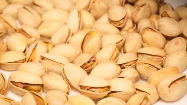 Pile Salted Roasted Pistachios Falls Plate Slow Motion Tasty Snack — Stock Video