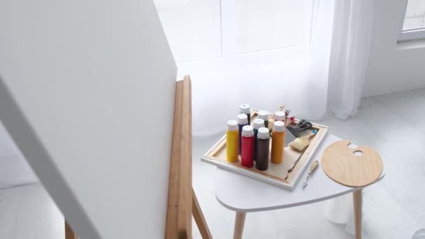 Jars Colored Paints Bones Spatulas Stand Artists Desk Easel White — Stock Video
