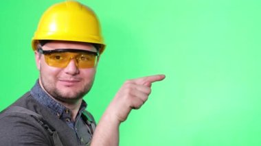 Tamircinin portresi izole edilmiş model şablonu ve parmakları işaret ediyor. Kromakey arka planda reklamcılık için yer