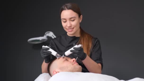Female Cosmetologist Performs Cavitation Procedure Rejuvenation Facial Skin Men — Stock Video