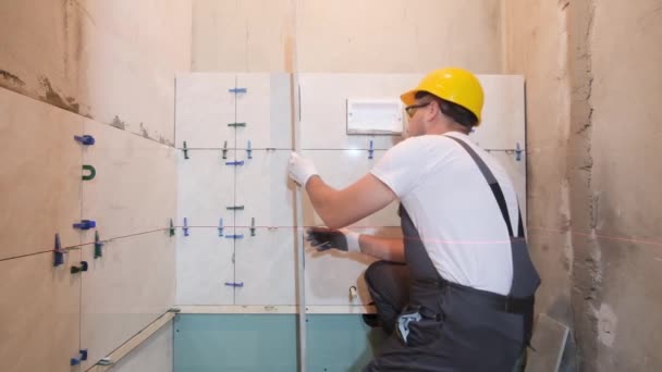 Byggare Säkerhetshjälm Kontrollerar Jämnheten Kakel Badrummet Byggarbetare Inspekterar Installationen Kakel — Stockvideo
