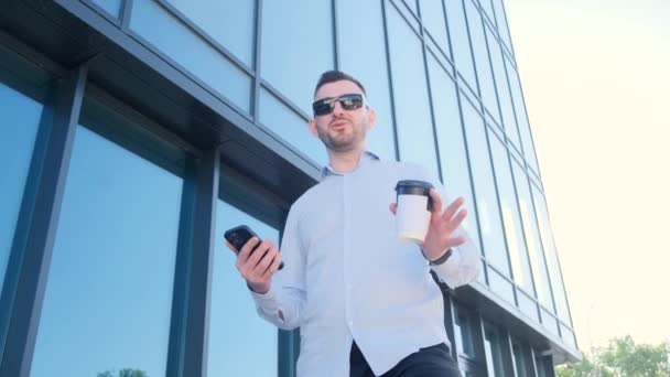 Handsome Man Standing Outdoors Skyscraper Drinking Coffee Talking Camera Successful — Vídeo de Stock