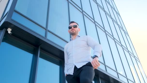 Young Man Stands Skyscraper Looks Smart Watch Office Manager Outdoors — Vídeo de Stock